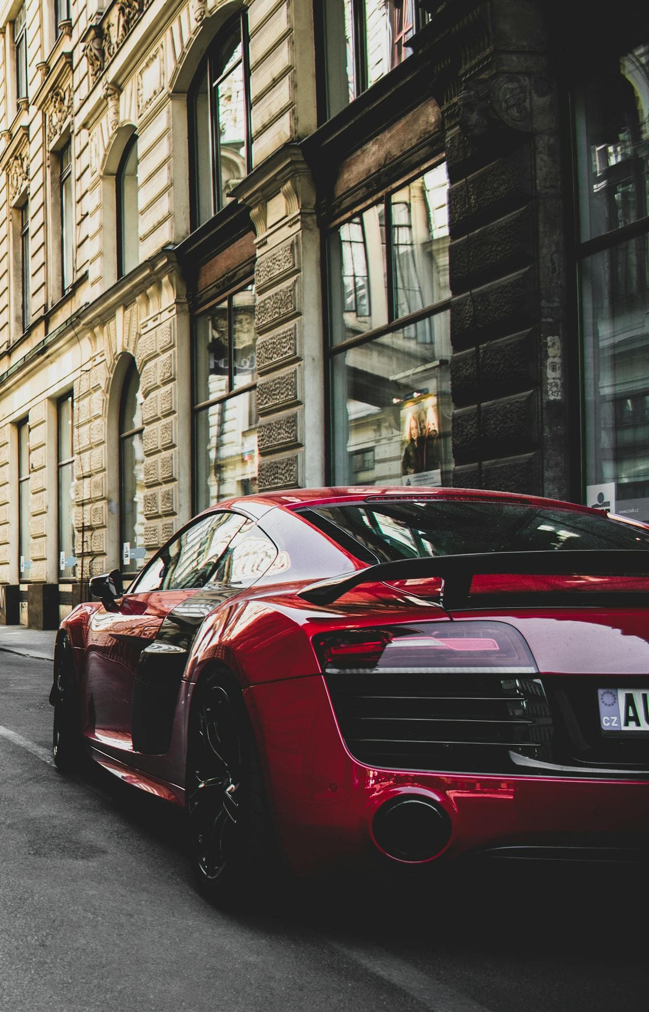 Red Audi R8 with a flawless finish parked on a city street